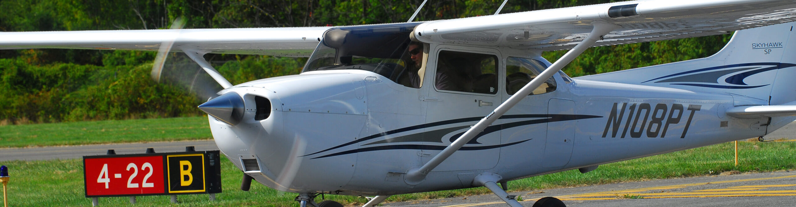 Cessna from Century Air Flight School landing on runway at KCDW airport in Caldwell, NJ.